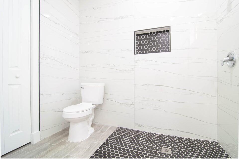 8126 Thruso Road Port Charlotte, FL 33981 - Photo 22 of 32 a bathroom with a toilet a sink and a shower