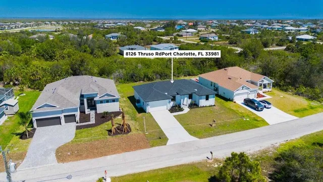 an aerial view of a house with garden space and street view