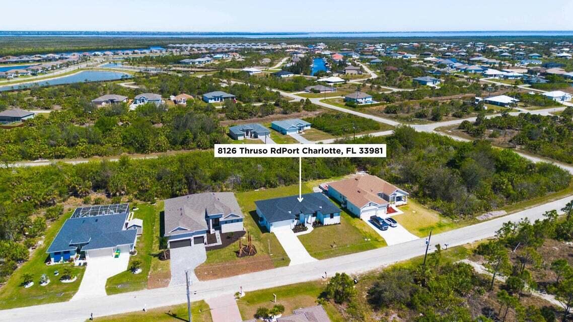8126 Thruso Road Port Charlotte, FL 33981 - Photo 29 of 32 an aerial view of residential houses with outdoor space and swimming pool