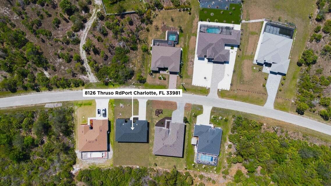 8126 Thruso Road Port Charlotte, FL 33981 - Photo 30 of 32 an aerial view of a house with swimming pool outdoor seating and yard