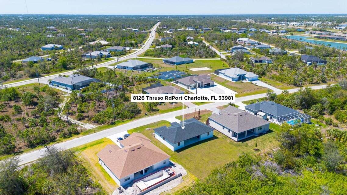 8126 Thruso Road Port Charlotte, FL 33981 - Photo 32 of 32 an aerial view of residential houses with outdoor space and river