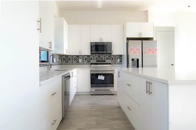 a kitchen with granite countertop a fireplace and a stove