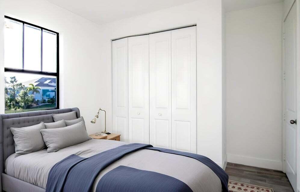 8126 Thruso Road Port Charlotte, FL 33981 - Photo 10 of 32 a bedroom with a bed and a window