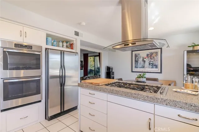 a kitchen with stainless steel appliances granite countertop a sink and a refrigerator