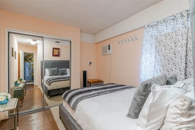 a bedroom with a bed and a mirror