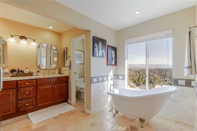 a spacious bathroom with a tub sink shower and mirror