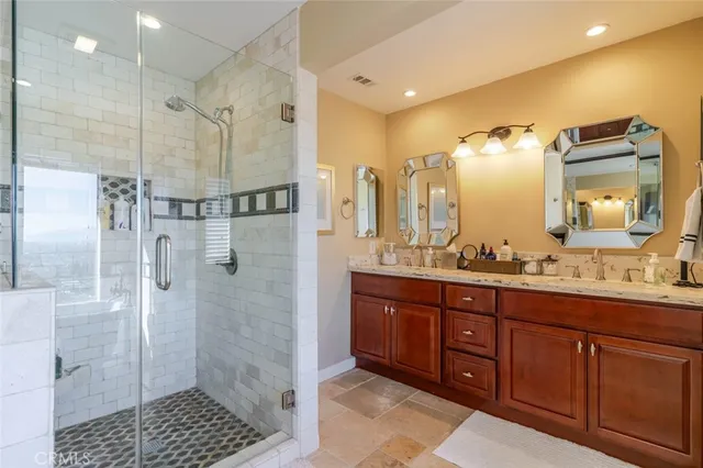 a bathroom with a granite countertop sink mirror and shower