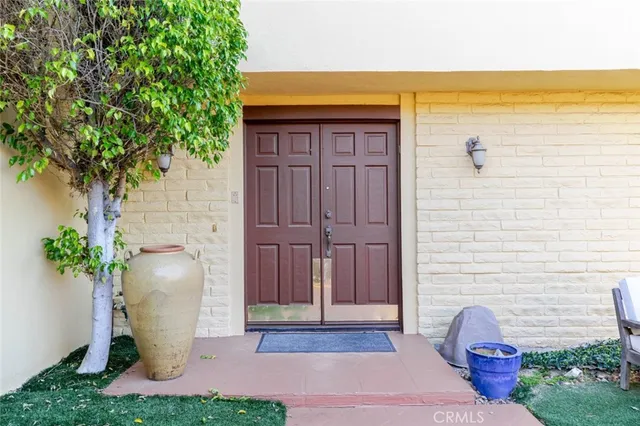 a view of a door and chair in the patio