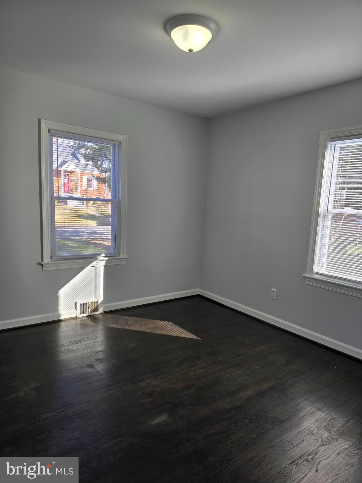 3910 74th Avenue Hyattsville, MD 20784 - Photo 11 of 23 a view of an empty room with wooden floor and a window