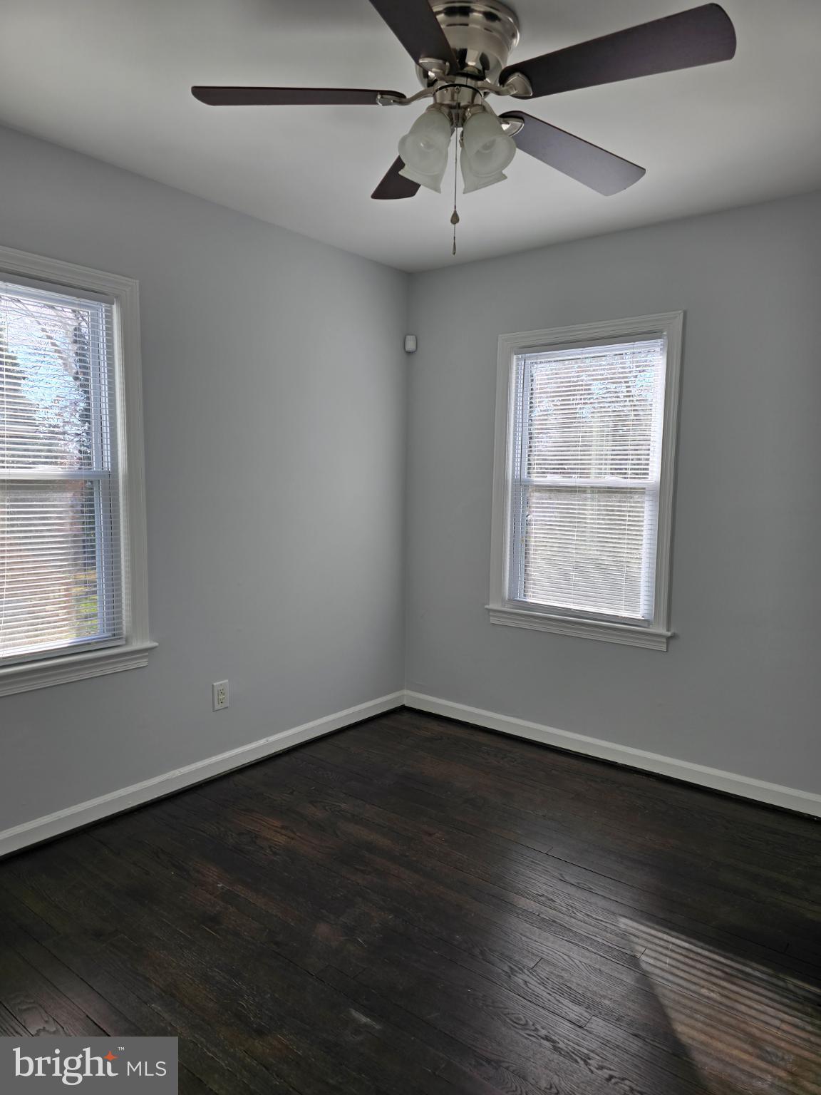 3910 74th Avenue Hyattsville, MD 20784 - Photo 13 of 23 a view of an empty room with wooden floor and a window