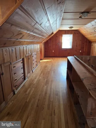 a view of a room with wooden floors