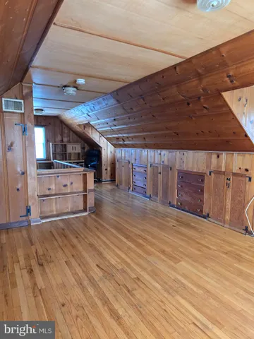 a view of a room with wooden floor