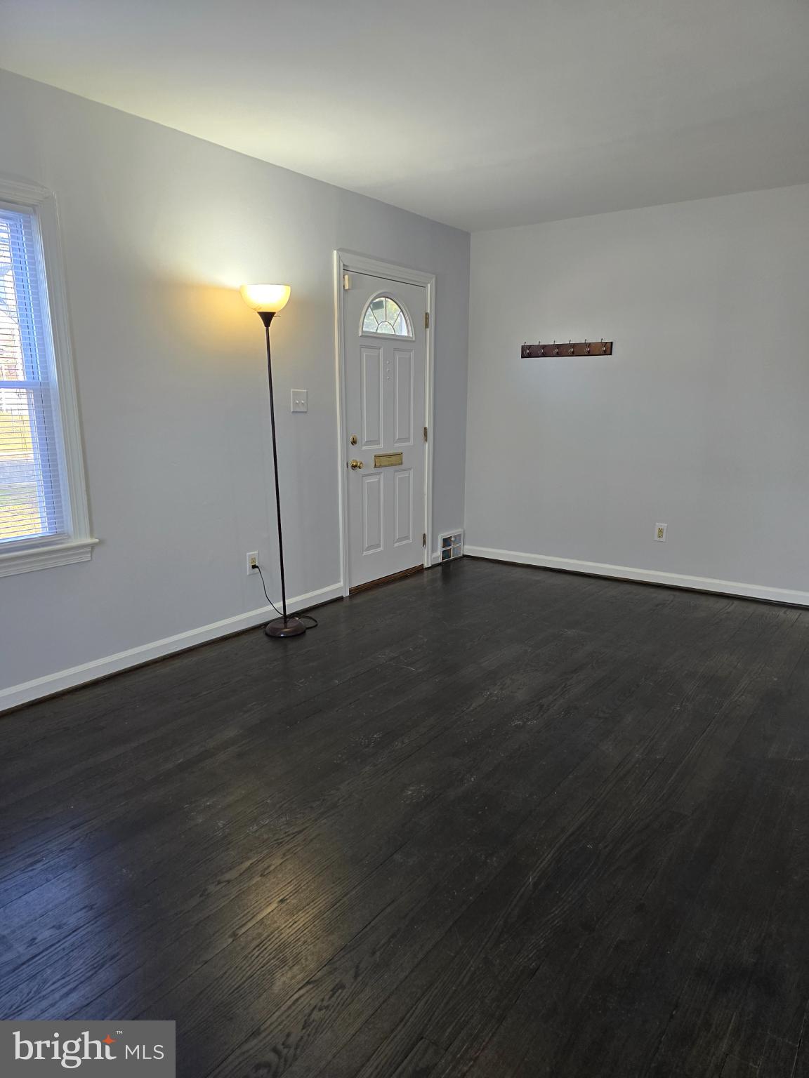 3910 74th Avenue Hyattsville, MD 20784 - Photo 2 of 23 an empty room with wooden floor and windows