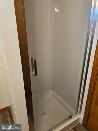 a white toilet sitting next to a shower