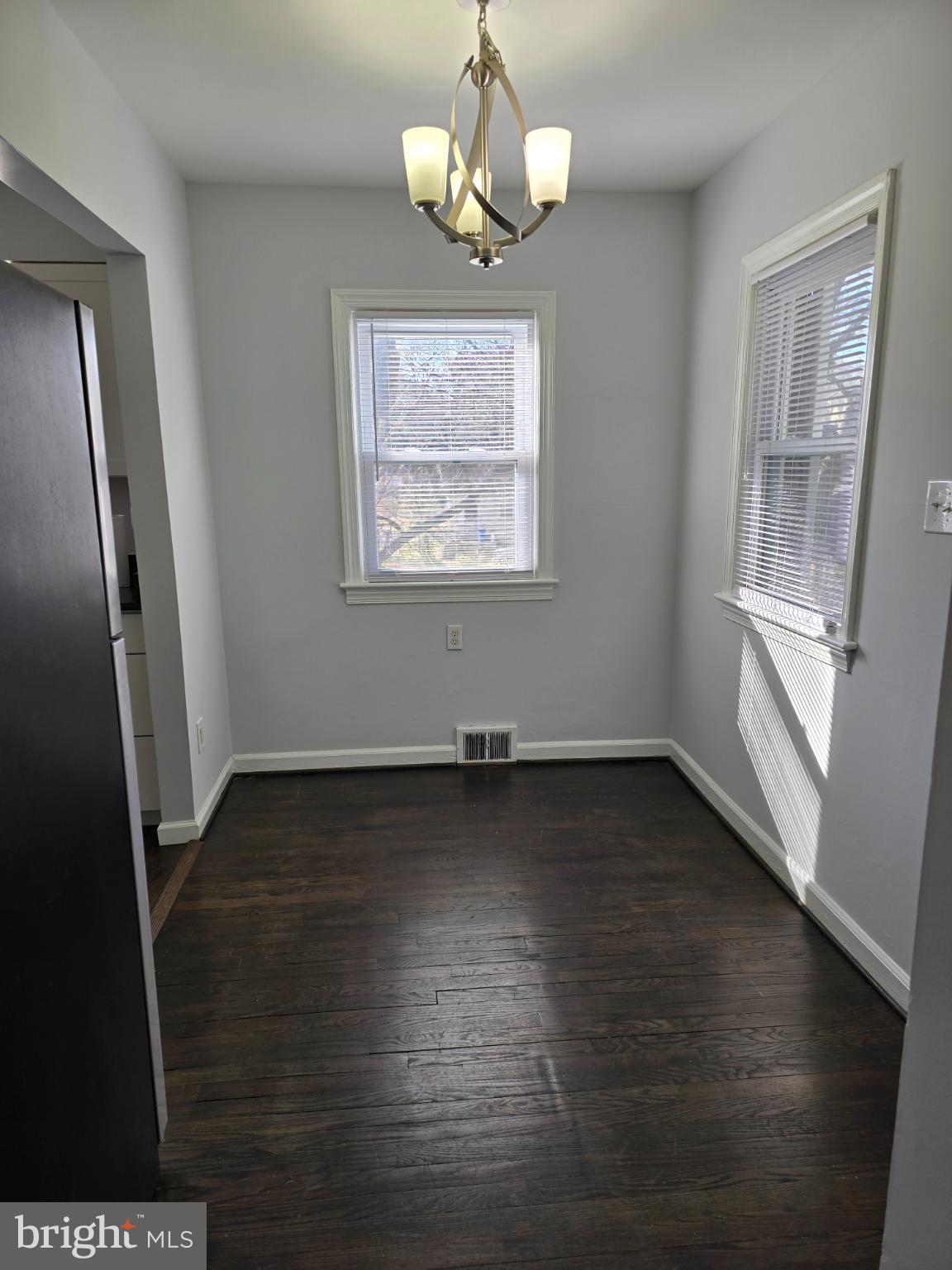 3910 74th Avenue Hyattsville, MD 20784 - Photo 3 of 23 an empty room with wooden floor and windows