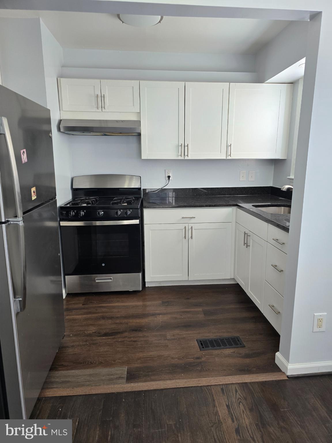 3910 74th Avenue Hyattsville, MD 20784 - Photo 6 of 23 a kitchen with granite countertop a stove and a sink