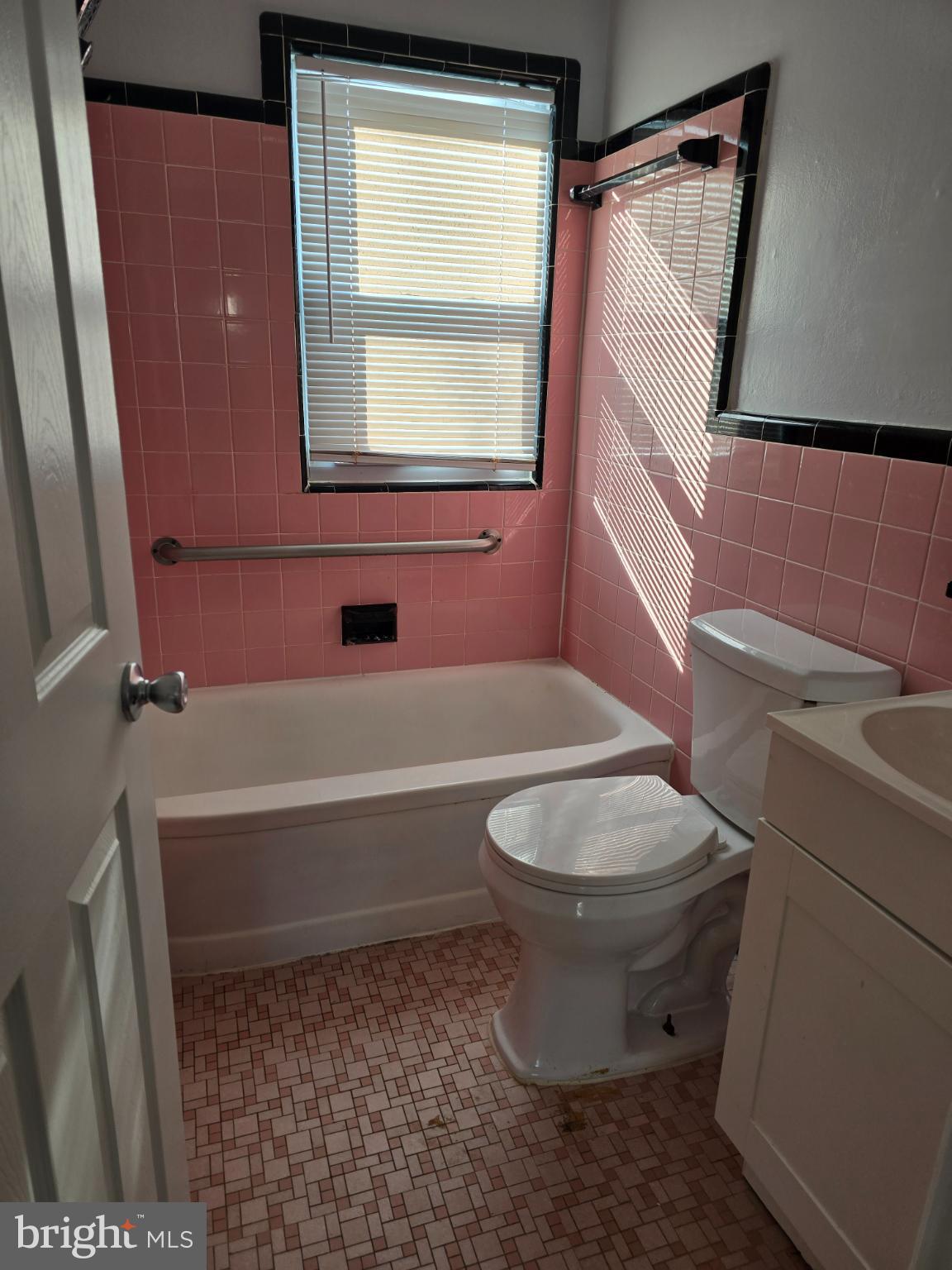 3910 74th Avenue Hyattsville, MD 20784 - Photo 9 of 23 a bathroom with a toilet a sink and a bathtub