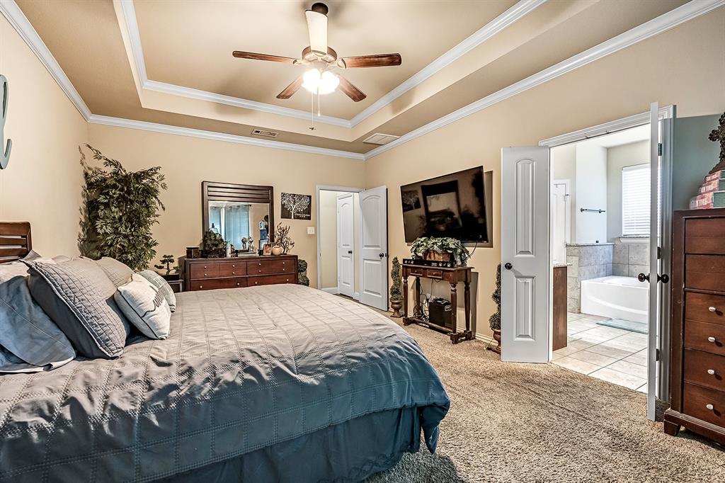 3206 Meadow Ridge Drive Midlothian, TX 76065 - Photo 19 of 37 a bedroom with a bed and a flat screen tv