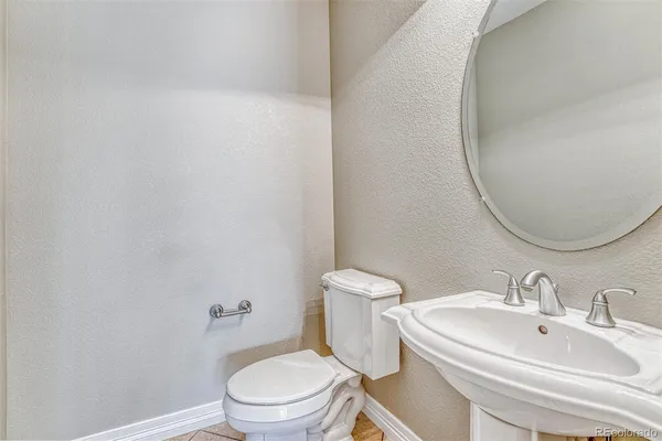 a white toilet sitting next to a bathroom sink