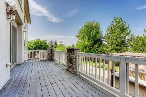 a view of deck with wooden floor and fence with a large garden