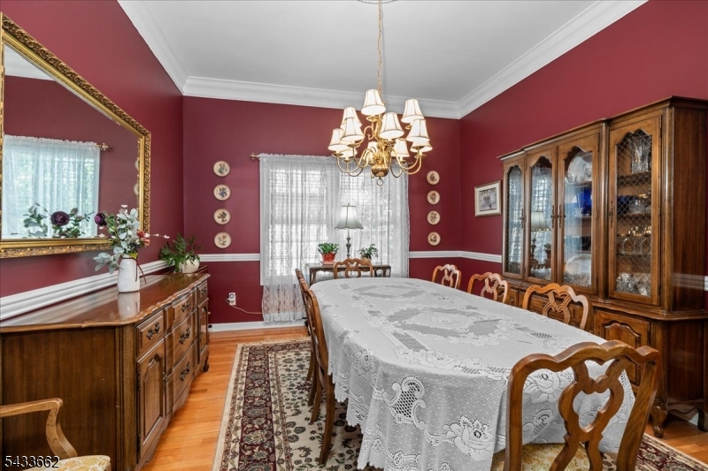15 Bracken Hill Road Hamburg, NJ 07419 - Photo 12 of 44 a view of a dining room with furniture and a chandelier