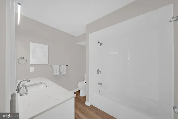 a bathroom with a sink a mirror and a bathtub