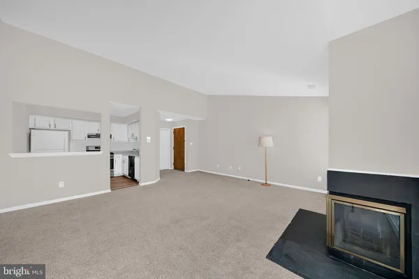 a view of an empty room with a fireplace