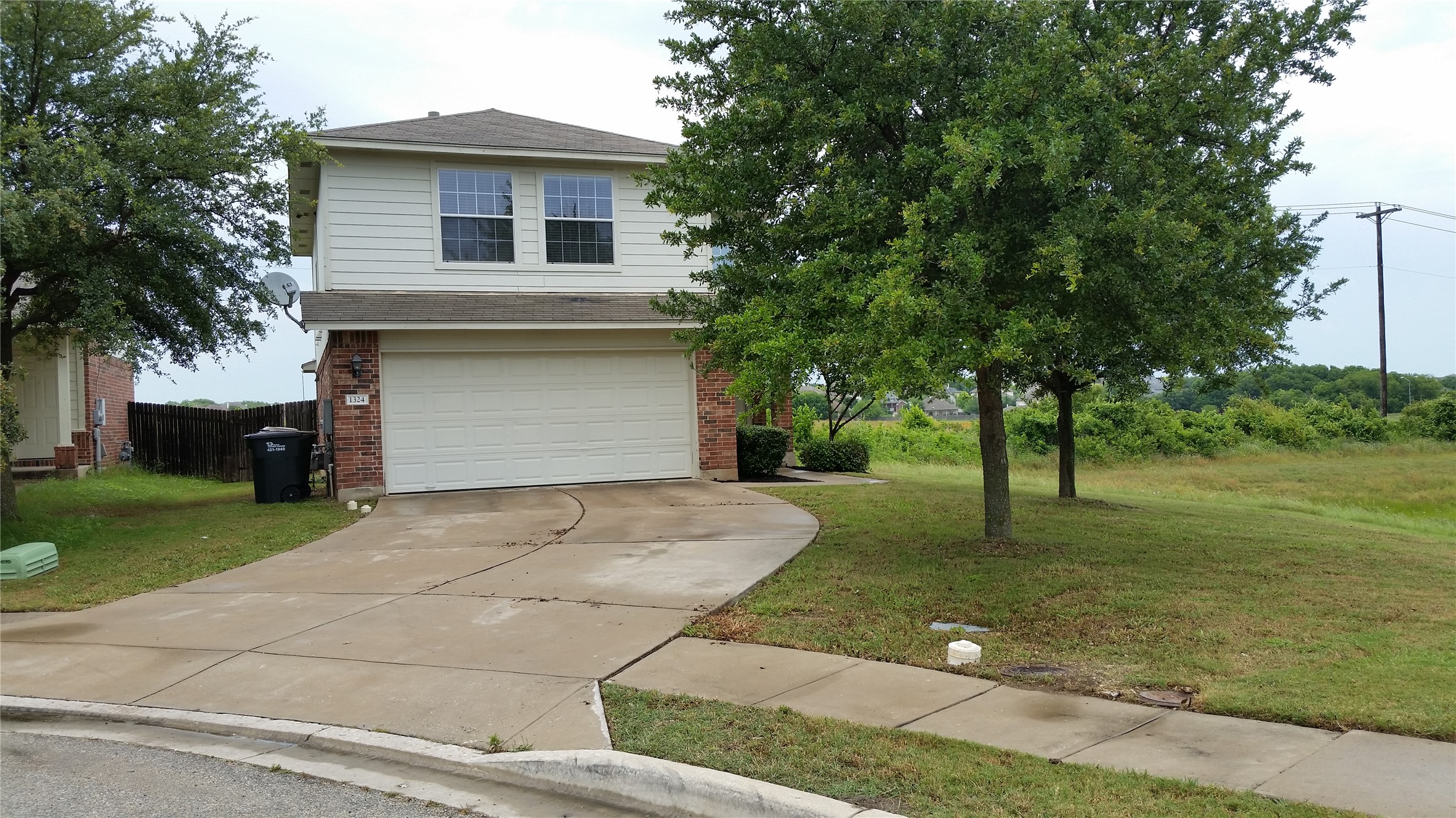 1324 Peppermint Trail Pflugerville, TX 78660 - Photo 1 of 33 View of front of house with brick siding, an attached garage, and driveway