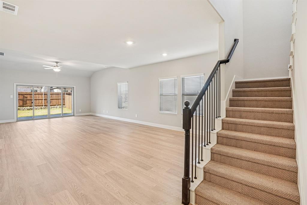 2621 Grand Cyn Street Anna, TX 75409 - Photo 13 of 37 a view of an empty room with wooden floor and fan