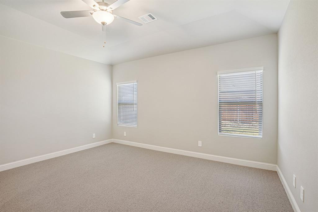 2621 Grand Cyn Street Anna, TX 75409 - Photo 18 of 37 an empty room with a chandelier fan and windows
