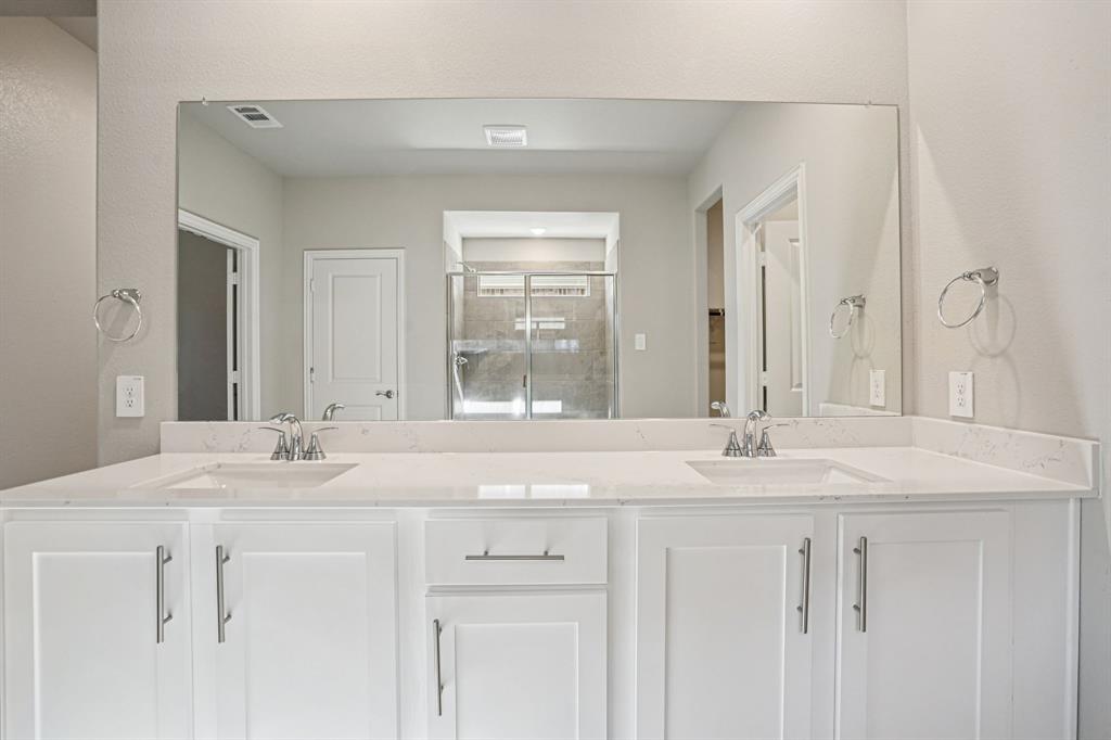 2621 Grand Cyn Street Anna, TX 75409 - Photo 21 of 37 a bathroom with a sink and a mirror