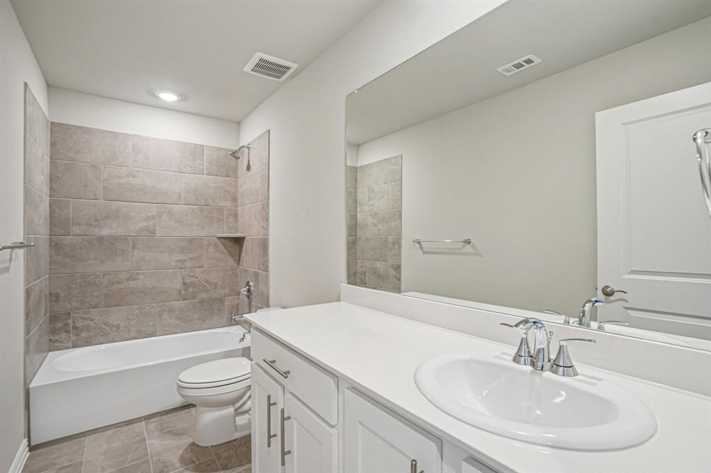 2621 Grand Cyn Street Anna, TX 75409 - Photo 26 of 37 a bathroom with a sink a toilet and shower