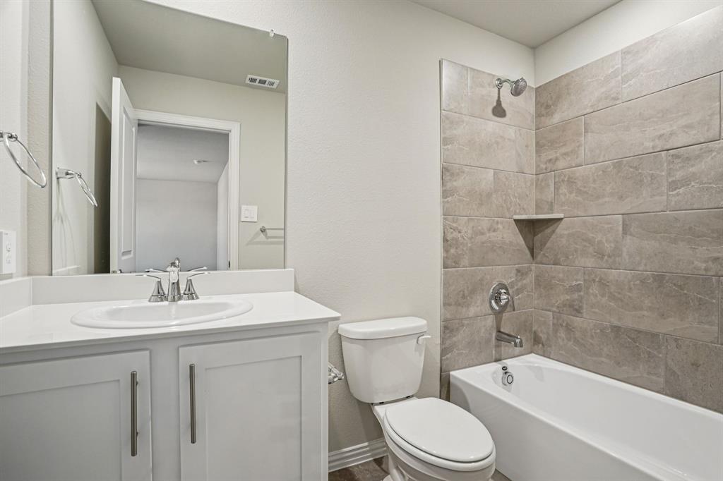 2621 Grand Cyn Street Anna, TX 75409 - Photo 34 of 37 a bathroom with a sink a toilet and shower