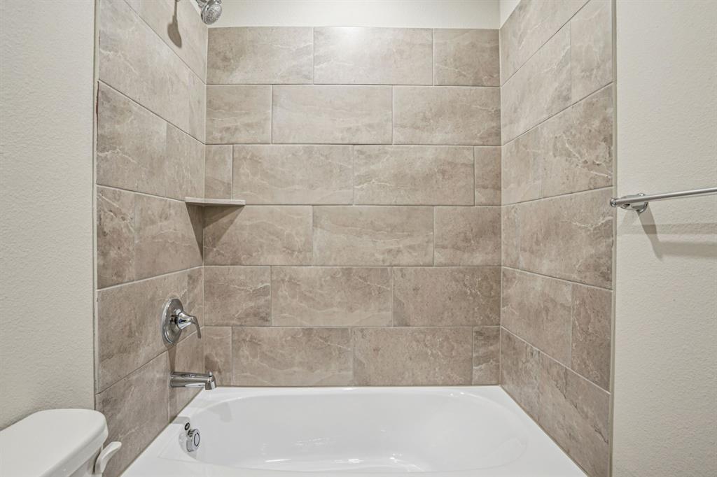 2621 Grand Cyn Street Anna, TX 75409 - Photo 35 of 37 a bathroom with a bathtub and toilet