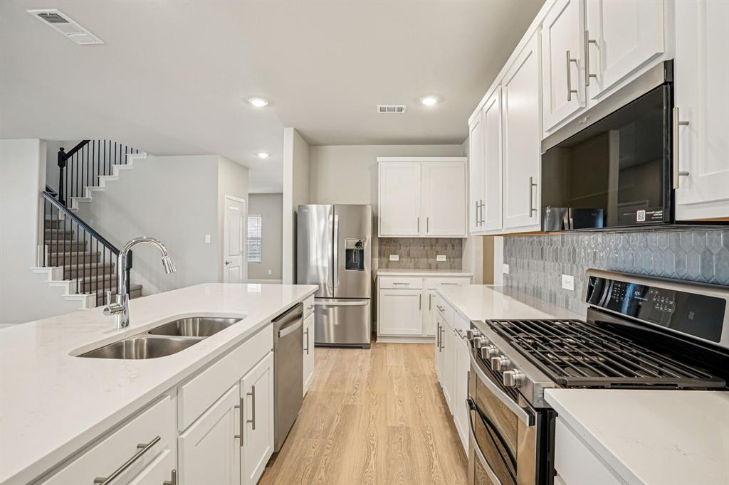 2621 Grand Cyn Street Anna, TX 75409 - Photo 6 of 37 a kitchen with a sink stove and refrigerator