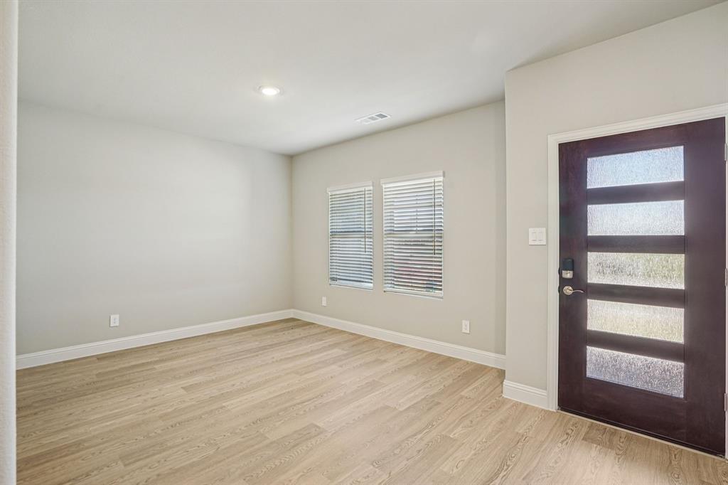 2621 Grand Cyn Street Anna, TX 75409 - Photo 7 of 37 a view of an empty room with wooden floor and a window