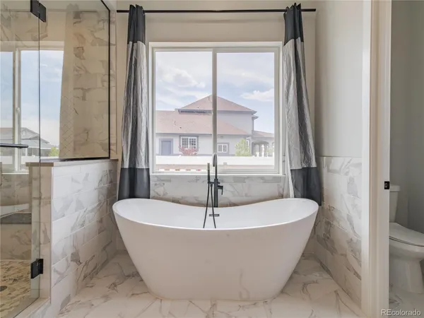 a white bath tub sitting next to a window