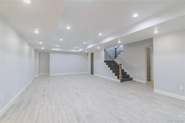 a view of an empty room with wooden floor