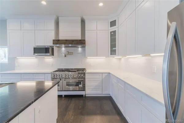 a kitchen with kitchen island white cabinets and a sink