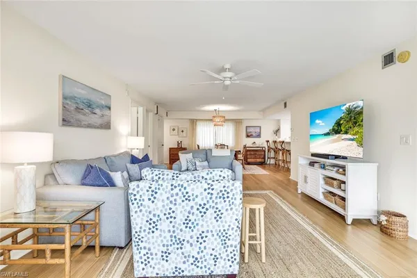 a living room with fireplace furniture and a table