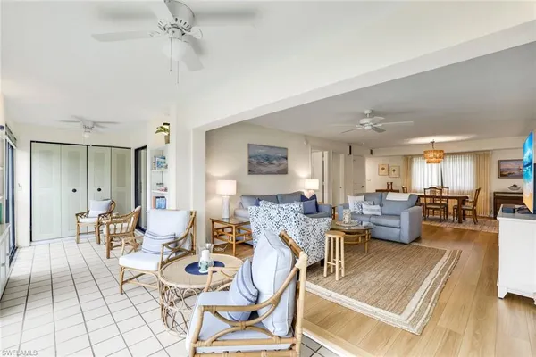 a view of a hallway with furniture and floor to ceiling window
