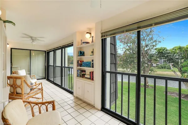 a balcony with furniture and large window