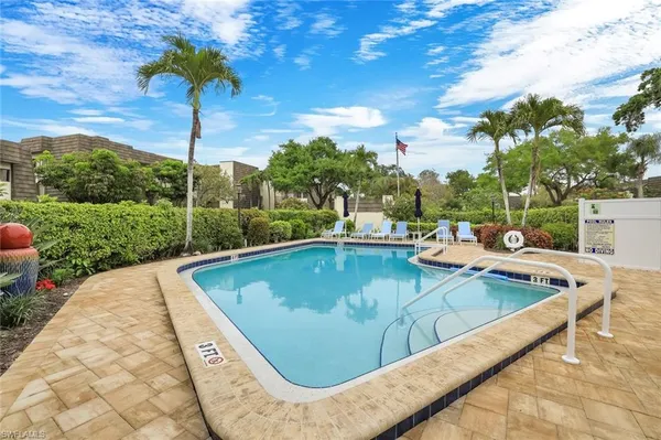 a view of a porch with a table and chairs