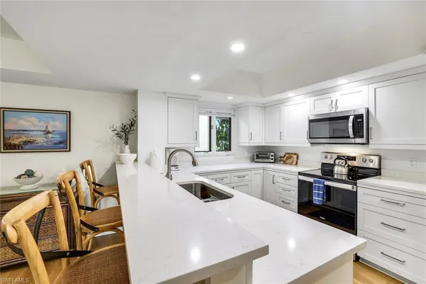 a kitchen with sink cabinets and wooden floor