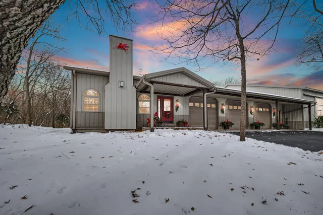 a patio with a table and chairs under an umbrella