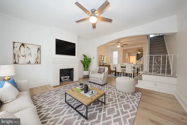 a living room with furniture a fireplace and a flat screen tv