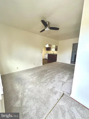 a view of a hallway with a ceiling fan