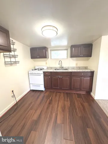 a kitchen with wooden floors and wooden cabinets