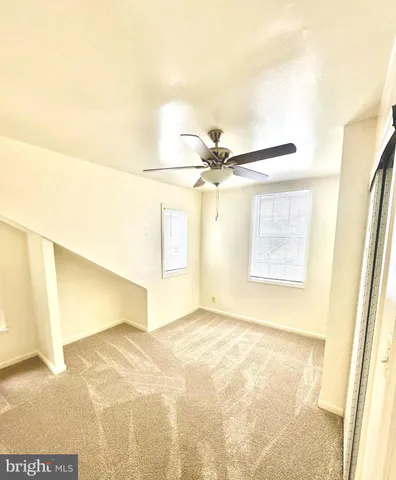 a view of a big room with wooden floor and cabinet