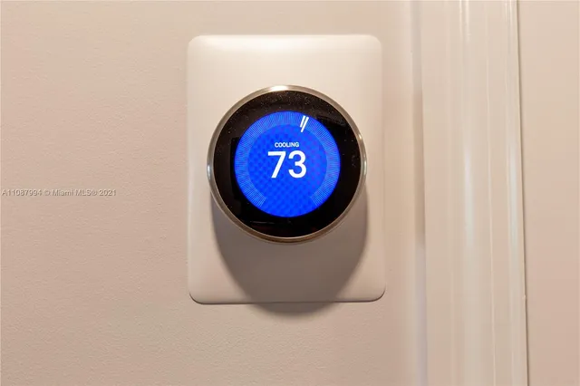 a living room with stainless steel appliances kitchen island granite countertop furniture and a large window